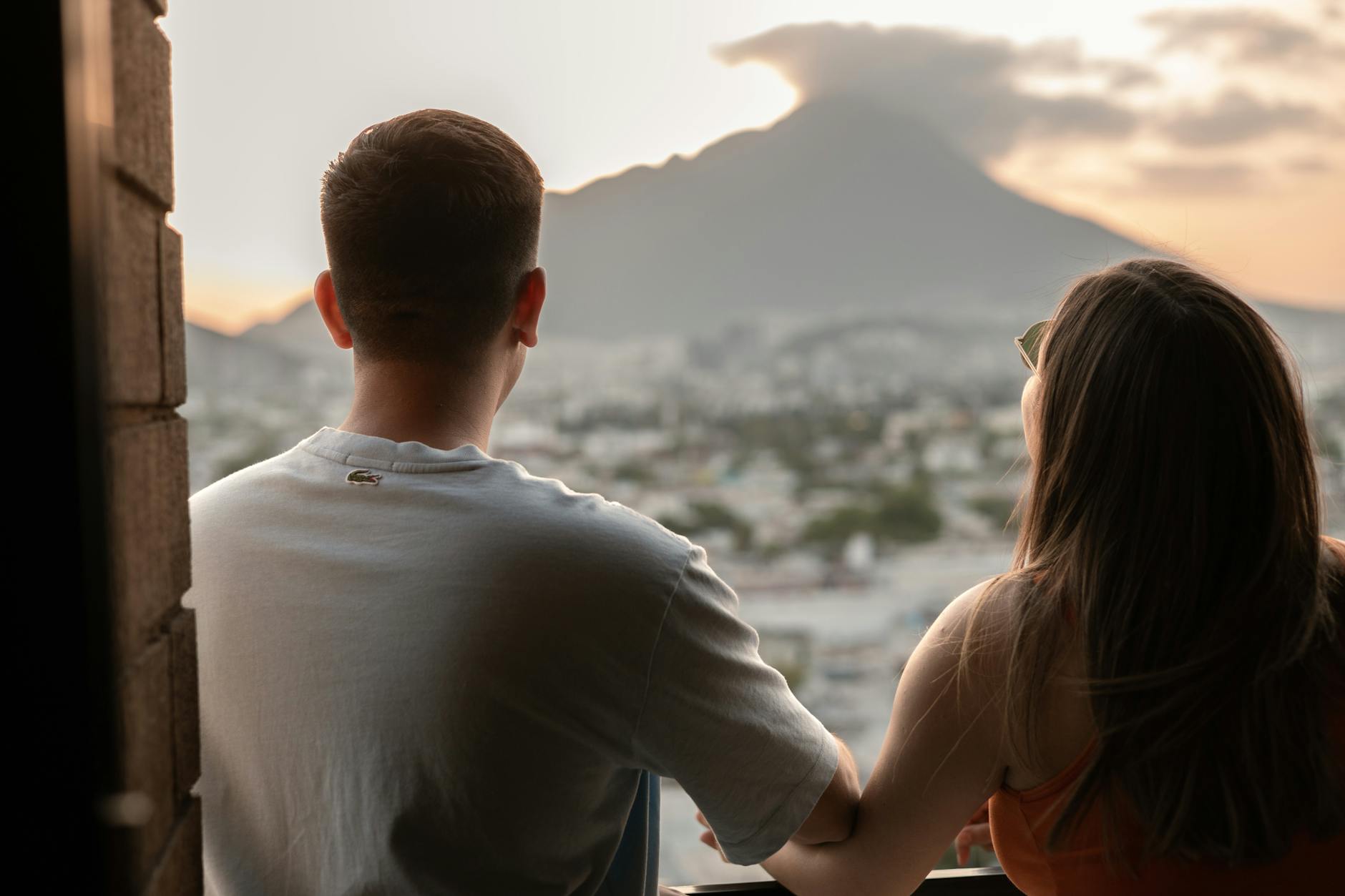 couple looking out at the city from a balcony