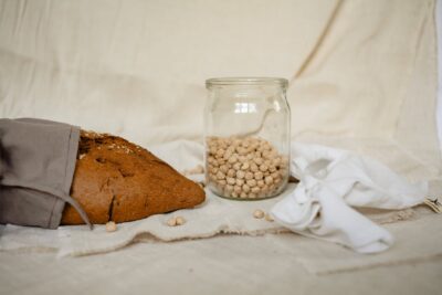 brown and white beans in clear glass jar