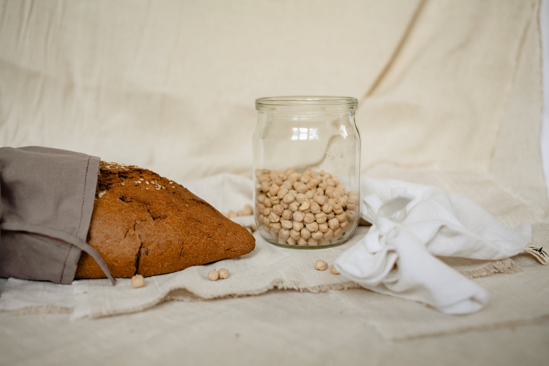 brown and white beans in clear glass jar